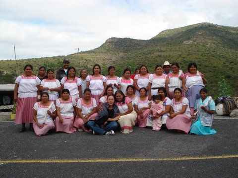 A group of women are posing for a picture on the side of the road