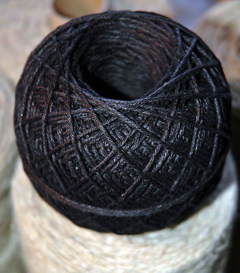 A close up of a ball of black yarn