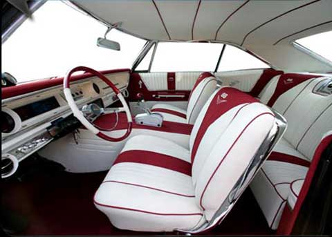 The inside of a car with red and white seats
