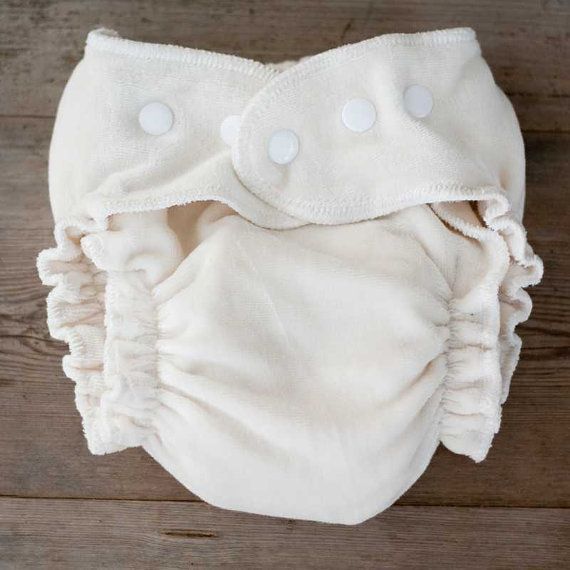 A white diaper is sitting on a wooden table