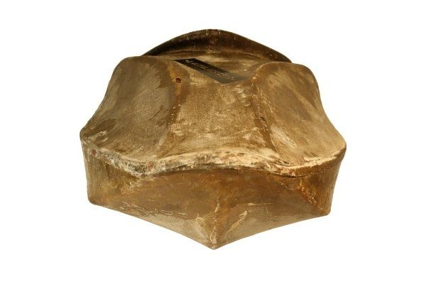 A brown object with a hole in the middle on a white background