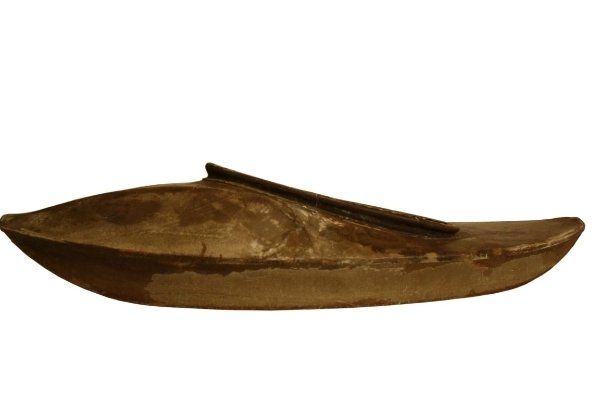 A wooden boat with a wooden paddle on a white background