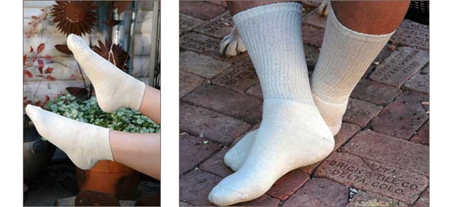 A pair of white socks on a person 's feet on a brick sidewalk.