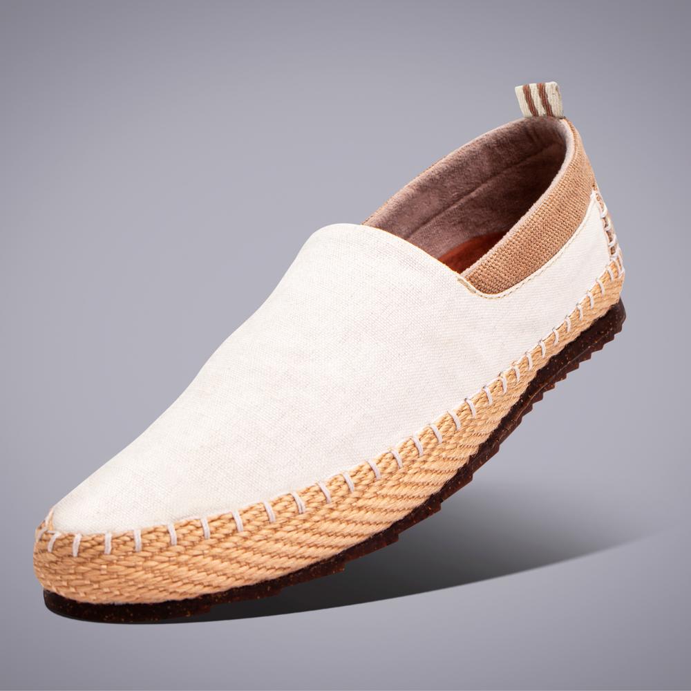 A pair of white shoes with a brown sole