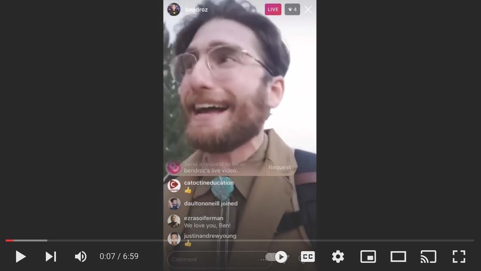 A man with a beard and glasses is smiling in a video.