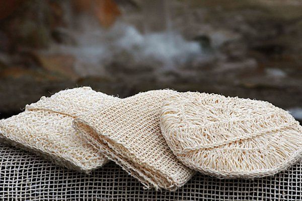 Three knitted hats are sitting on top of each other on a table.