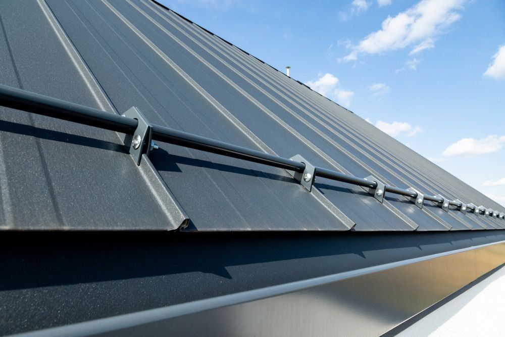 A Close Up of a Roof With Snow Guards on It — Rhythm Roofing in North Boambee Valley, NSW