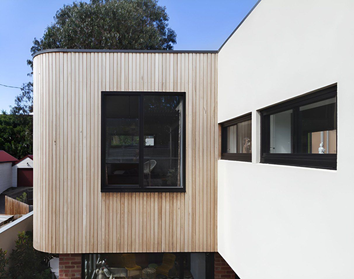 A White House With a Wooden Siding and Black Windows — Rhythm Roofing in Ballina, NSW