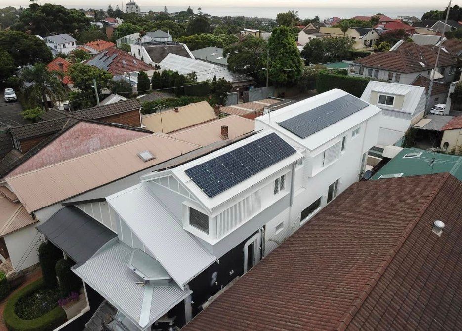 An Aerial View of a House With Solar Panels on the Roof — Rhythm Roofing in Lismore, NSW
