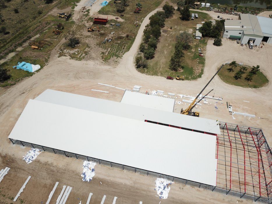 An Aerial View of a Large White Building Under Construction — Rhythm Roofing in North Boambee Valley, NSW