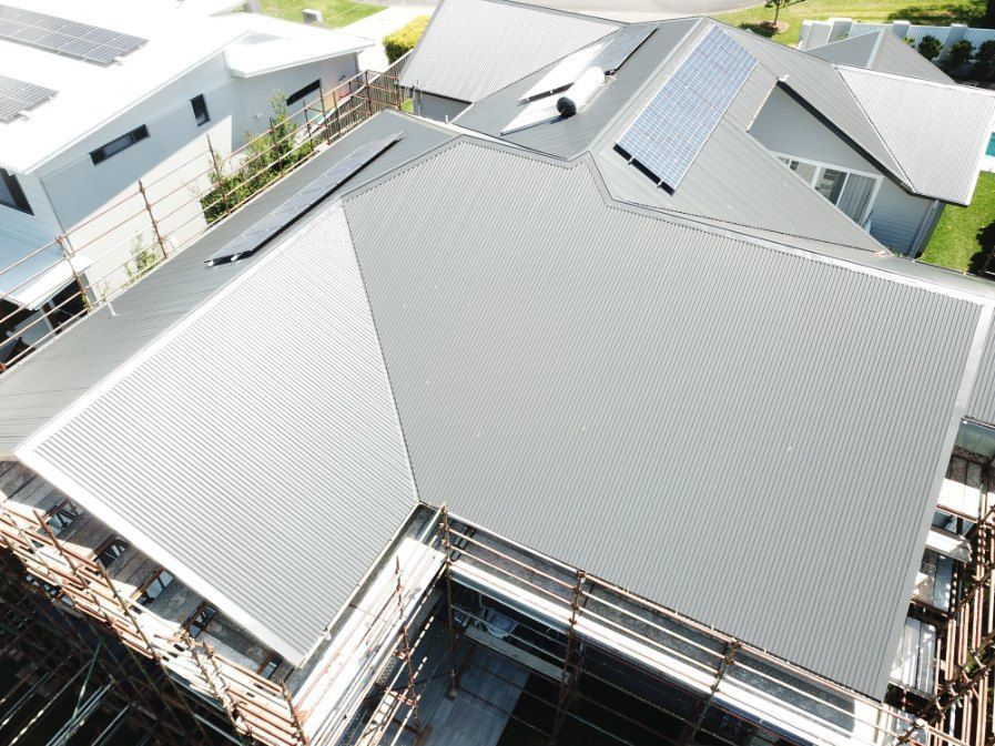 An Aerial View of a House Under Construction With a Gray Roof — Rhythm Roofing in Lismore, NSW