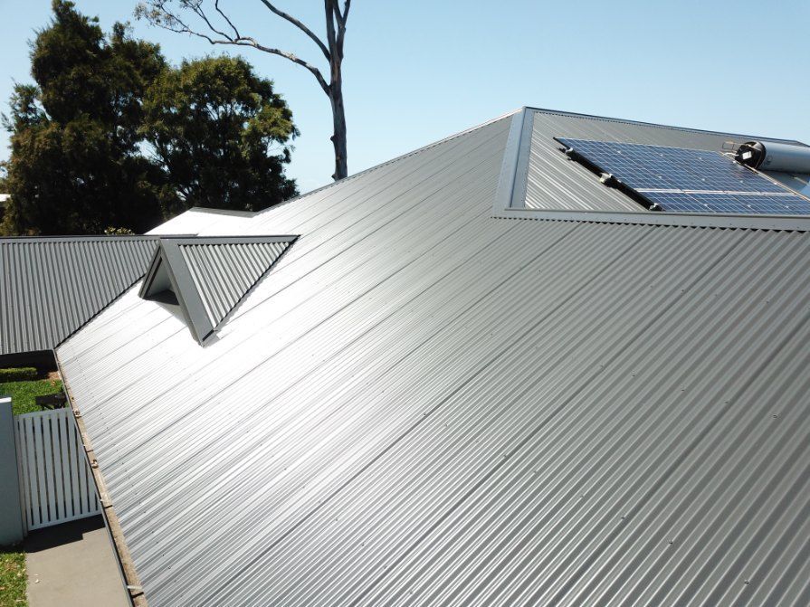 A Roof With a Solar Panel on Top of It — Rhythm Roofing in North Boambee Valley, NSW