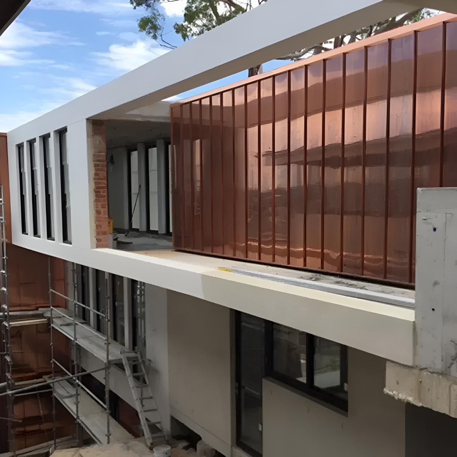 A Building With a Copper Facade is Being Built — Rhythm Roofing in North Boambee Valley, NSW