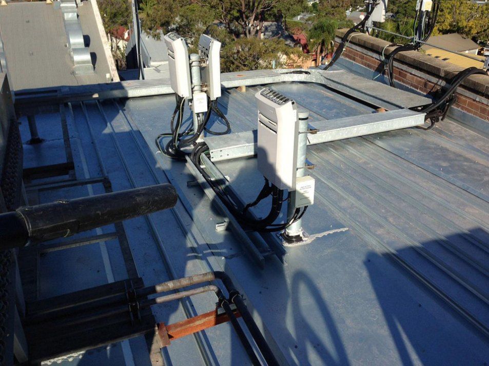 A Roof With a Lot of Wires on It — Rhythm Roofing in North Boambee Valley, NSW