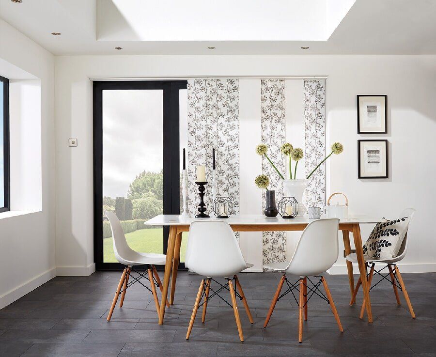 A panel door in Mackay with custom built panel glide blinds including a floral pattern - Deluxe Shutters & Blinds