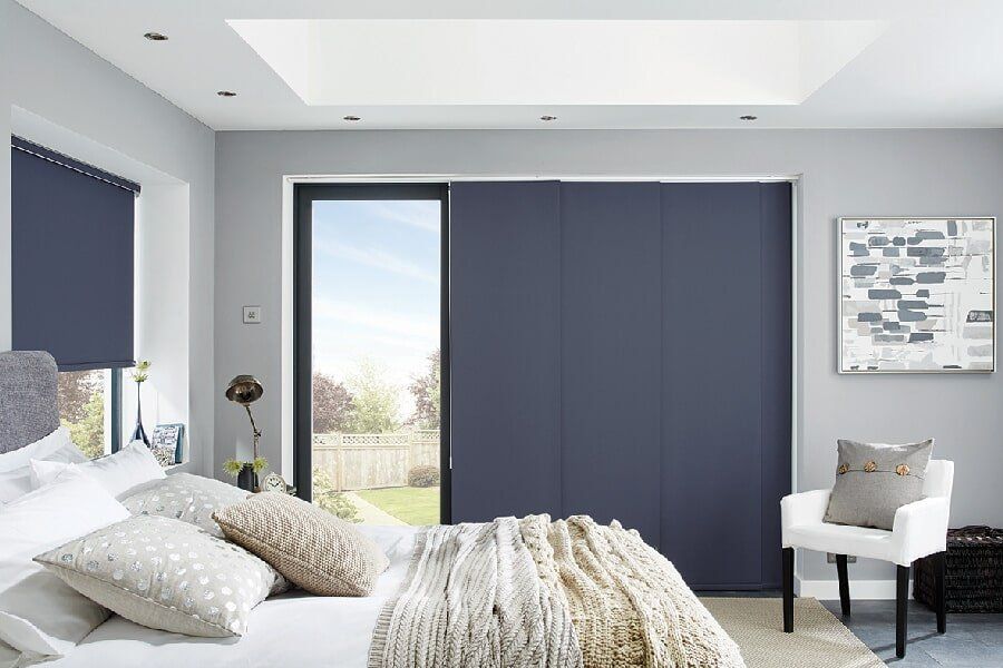 Navy Panel Glide Blinds in a Mackay Bedroom slightly opened - Deluxe Shutters & Blinds