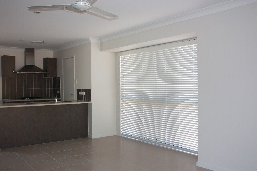 White Venetian Blinds in a Wide Glass Window | Venetian Blinds in Mackay