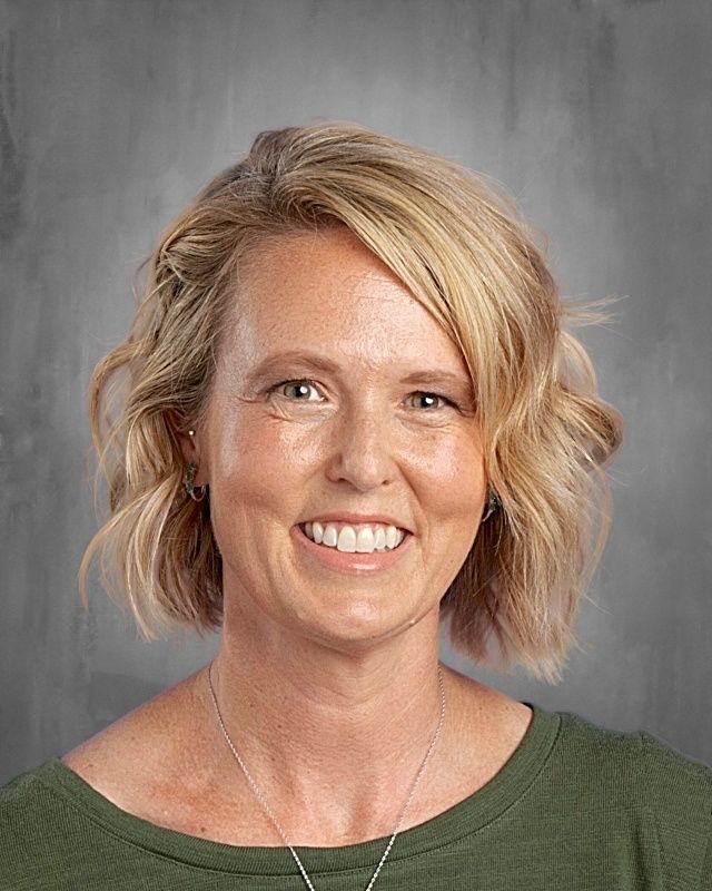 Young man in a blazer and white shirt, with blonde hair and a goatee, looking at the viewer.
