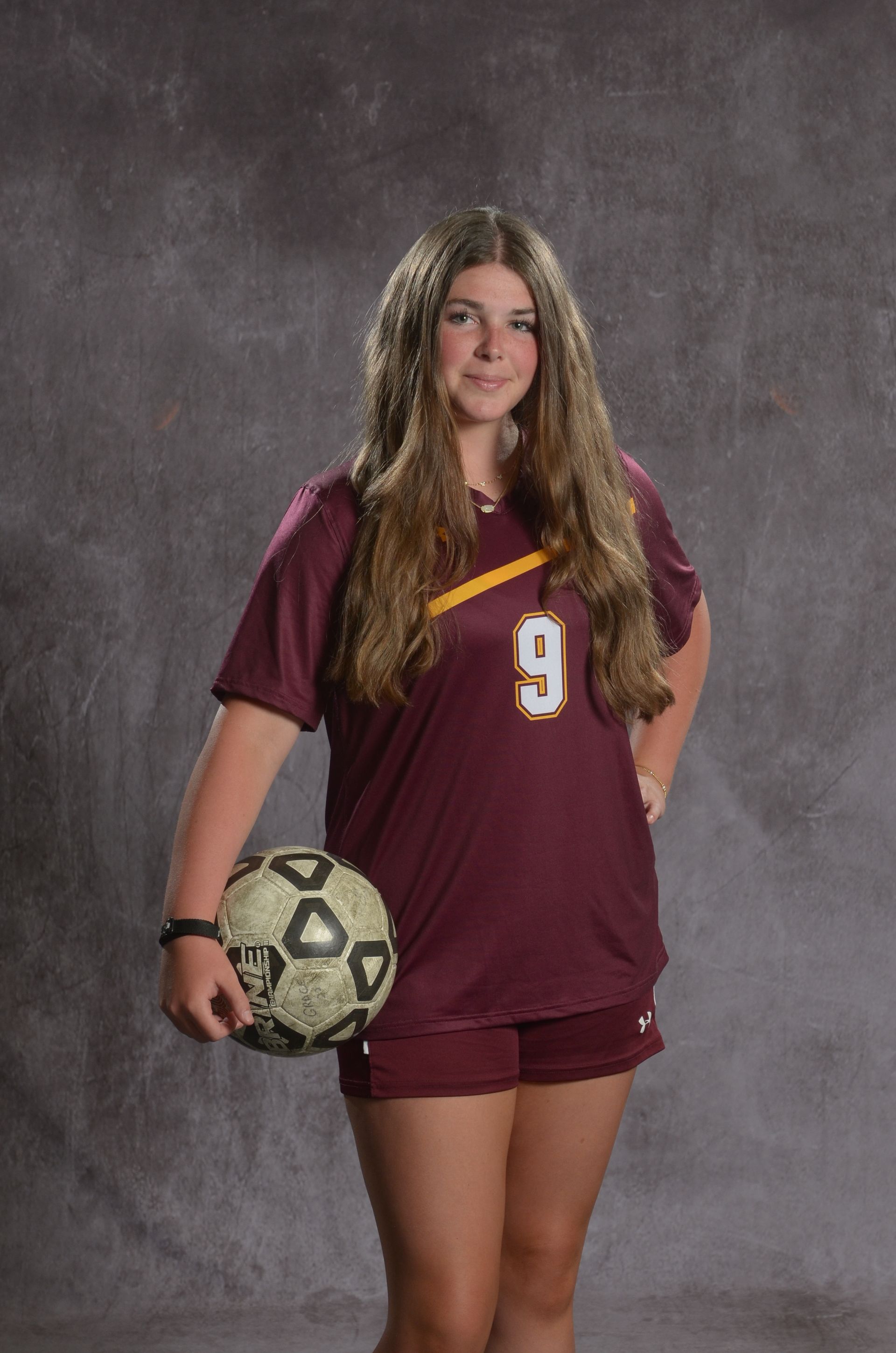 Eagle head logo, maroon feathers and yellow beak, facing right.
