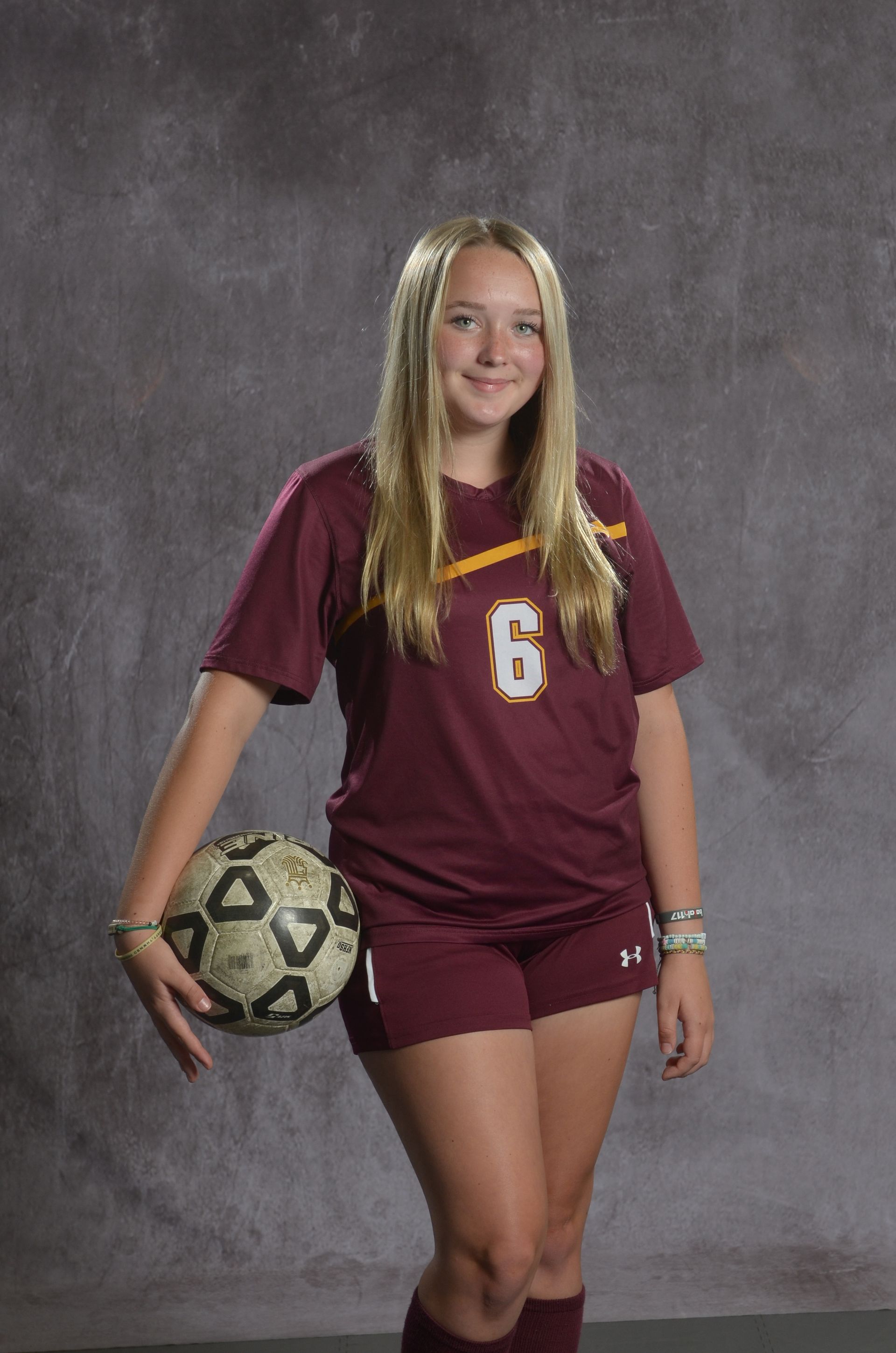 Eagle head logo, maroon feathers and yellow beak, facing right.