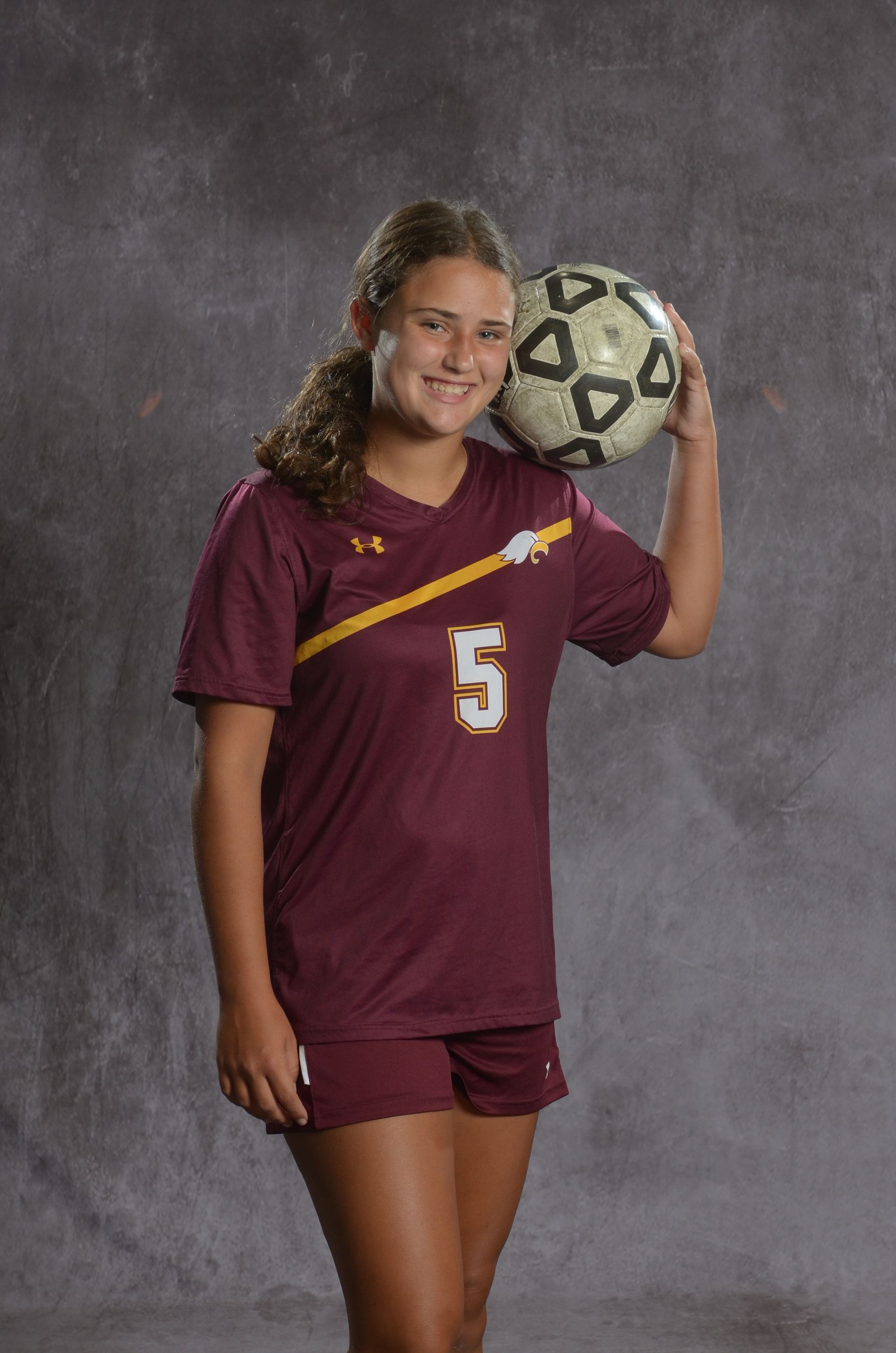 Eagle head logo, maroon feathers and yellow beak, facing right.