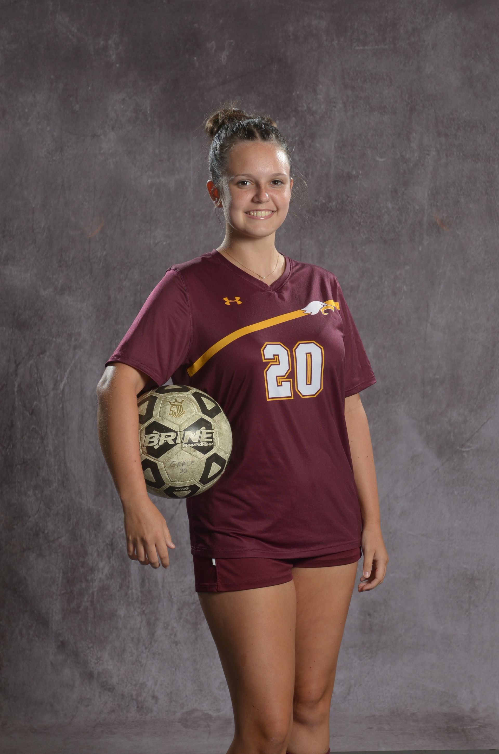 Eagle head logo, maroon feathers and yellow beak, facing right.