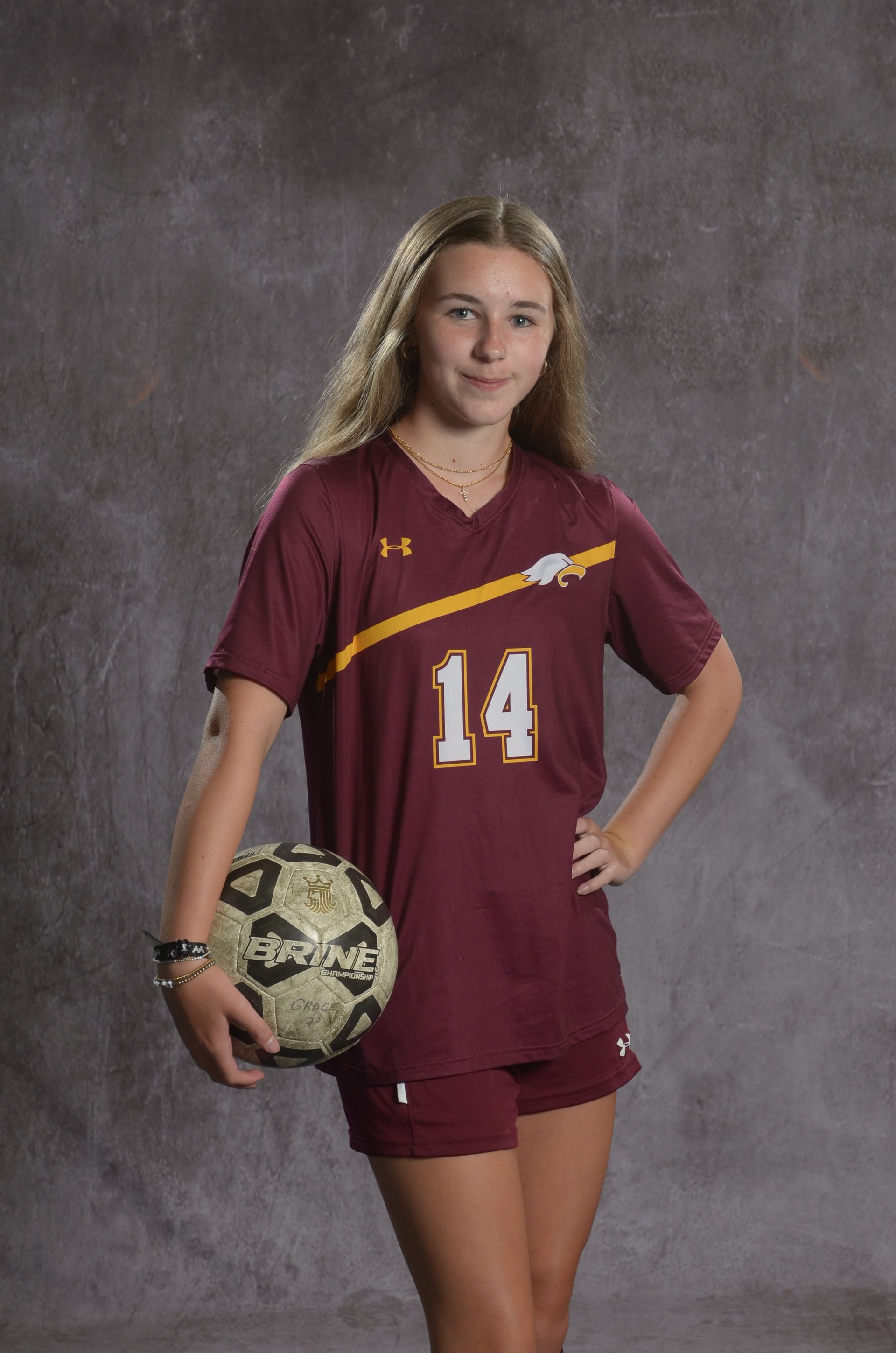 Eagle head logo, maroon feathers and yellow beak, facing right.