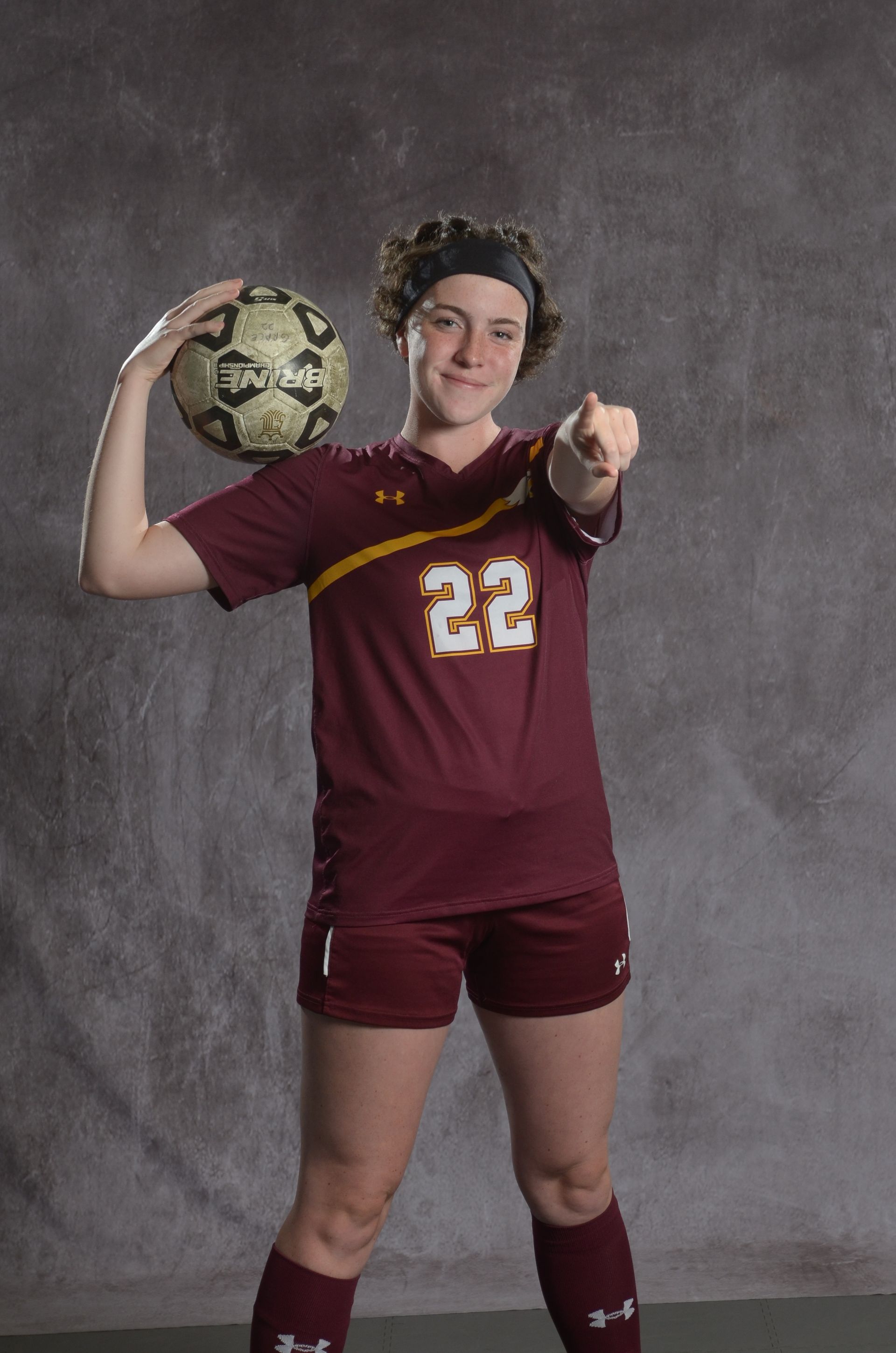 Eagle head logo, maroon feathers and yellow beak, facing right.