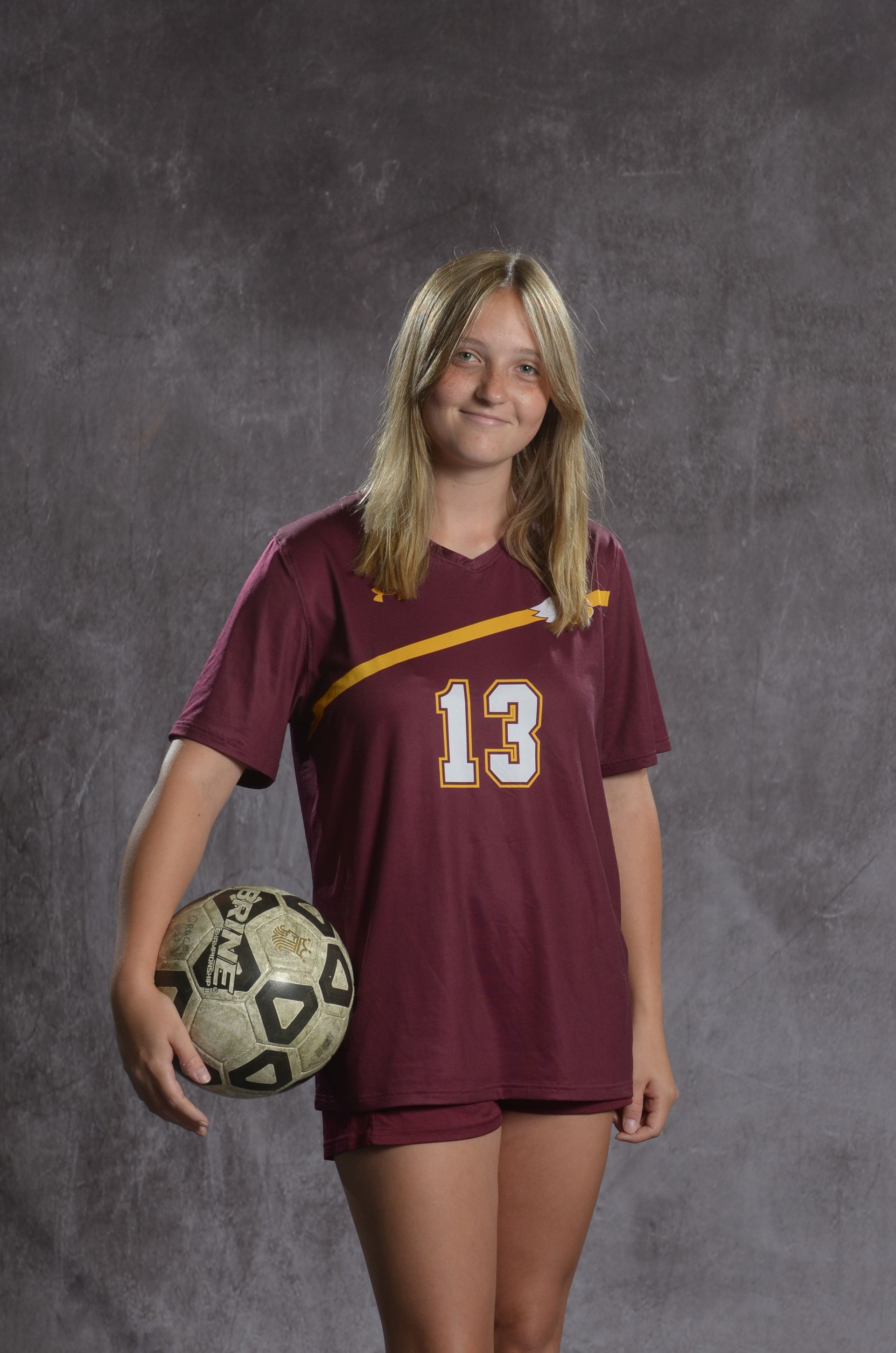 Eagle head logo, maroon feathers and yellow beak, facing right.