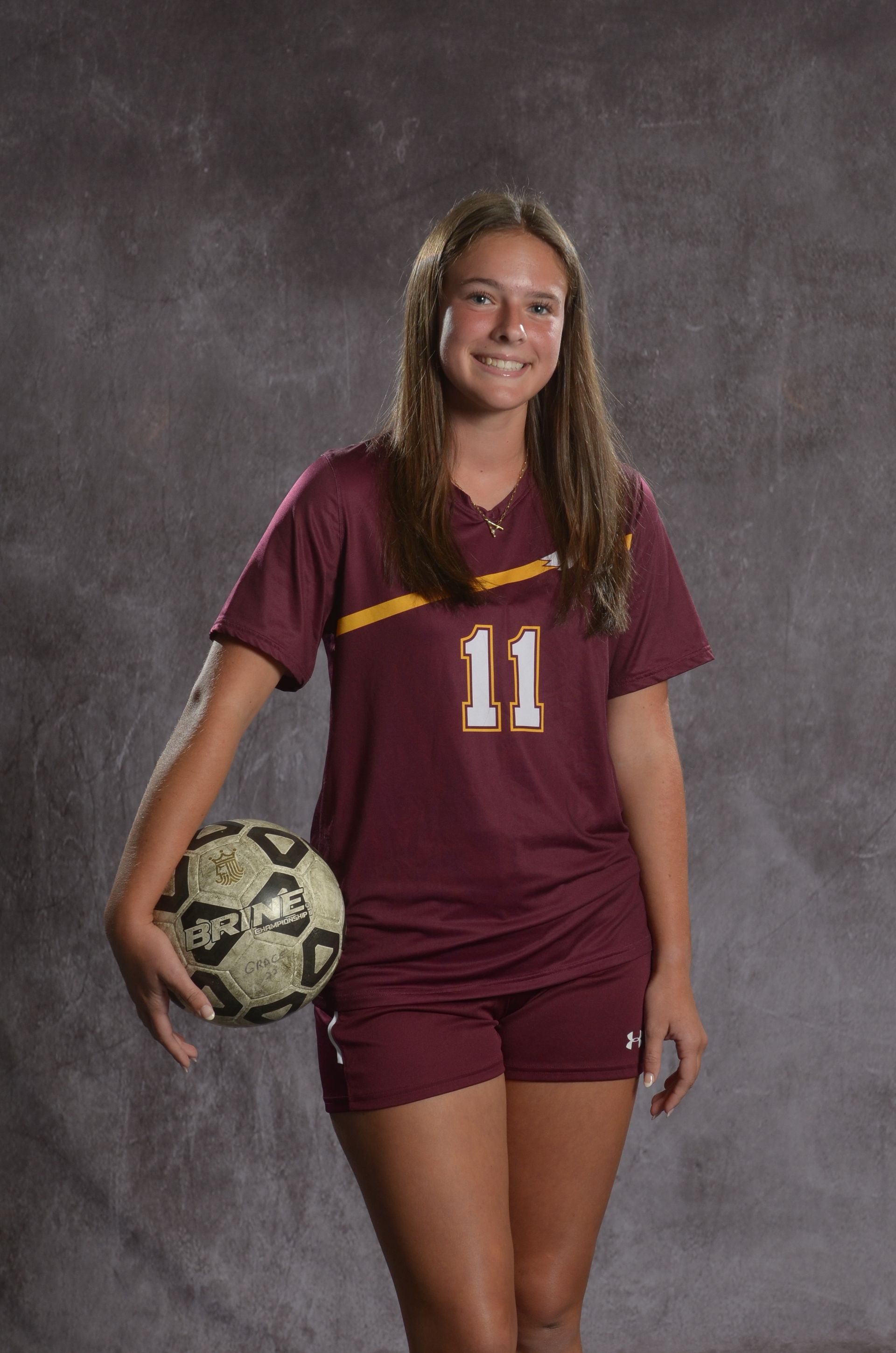 Eagle head logo, maroon feathers and yellow beak, facing right.