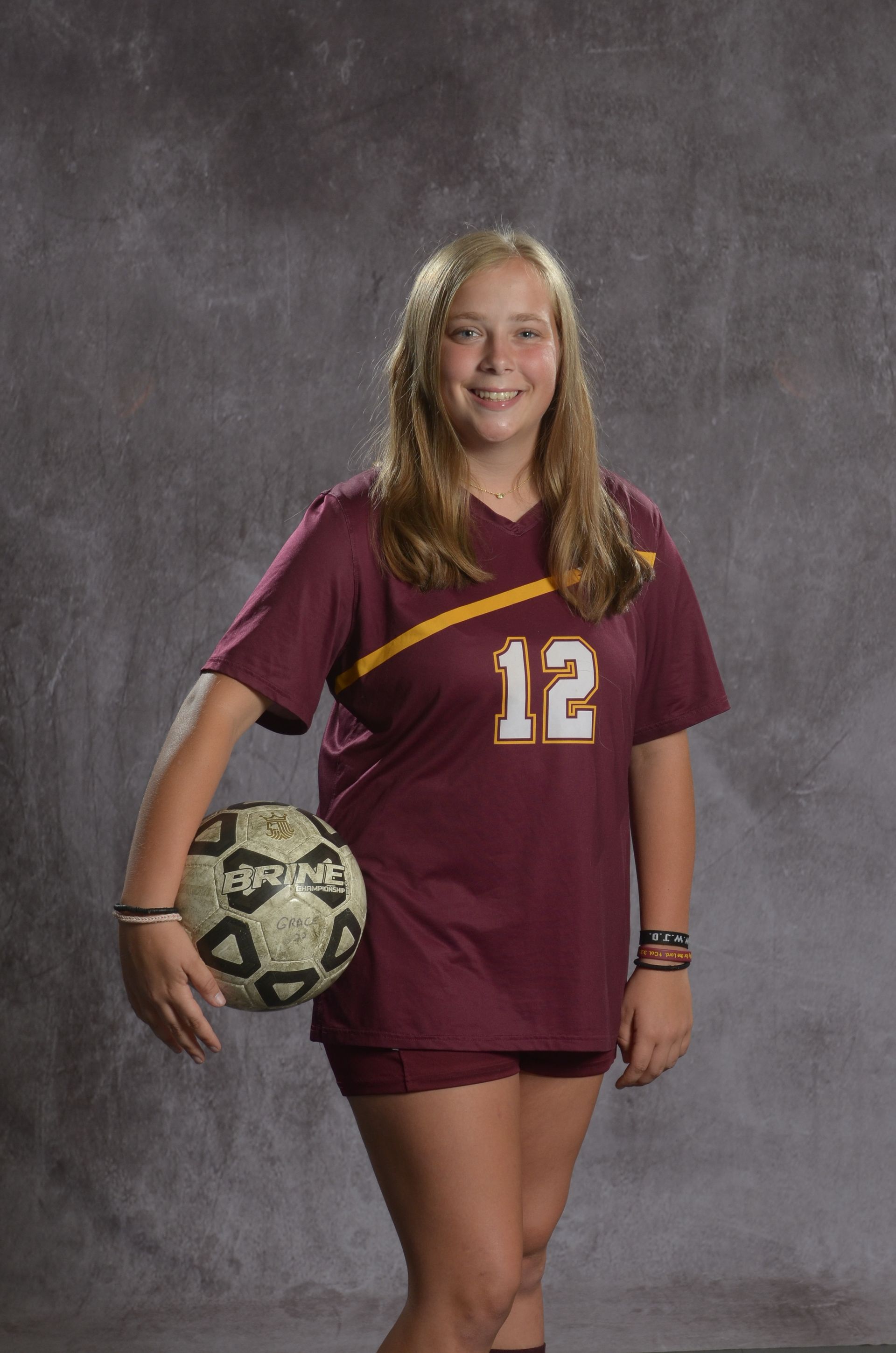 Eagle head logo, maroon feathers and yellow beak, facing right.