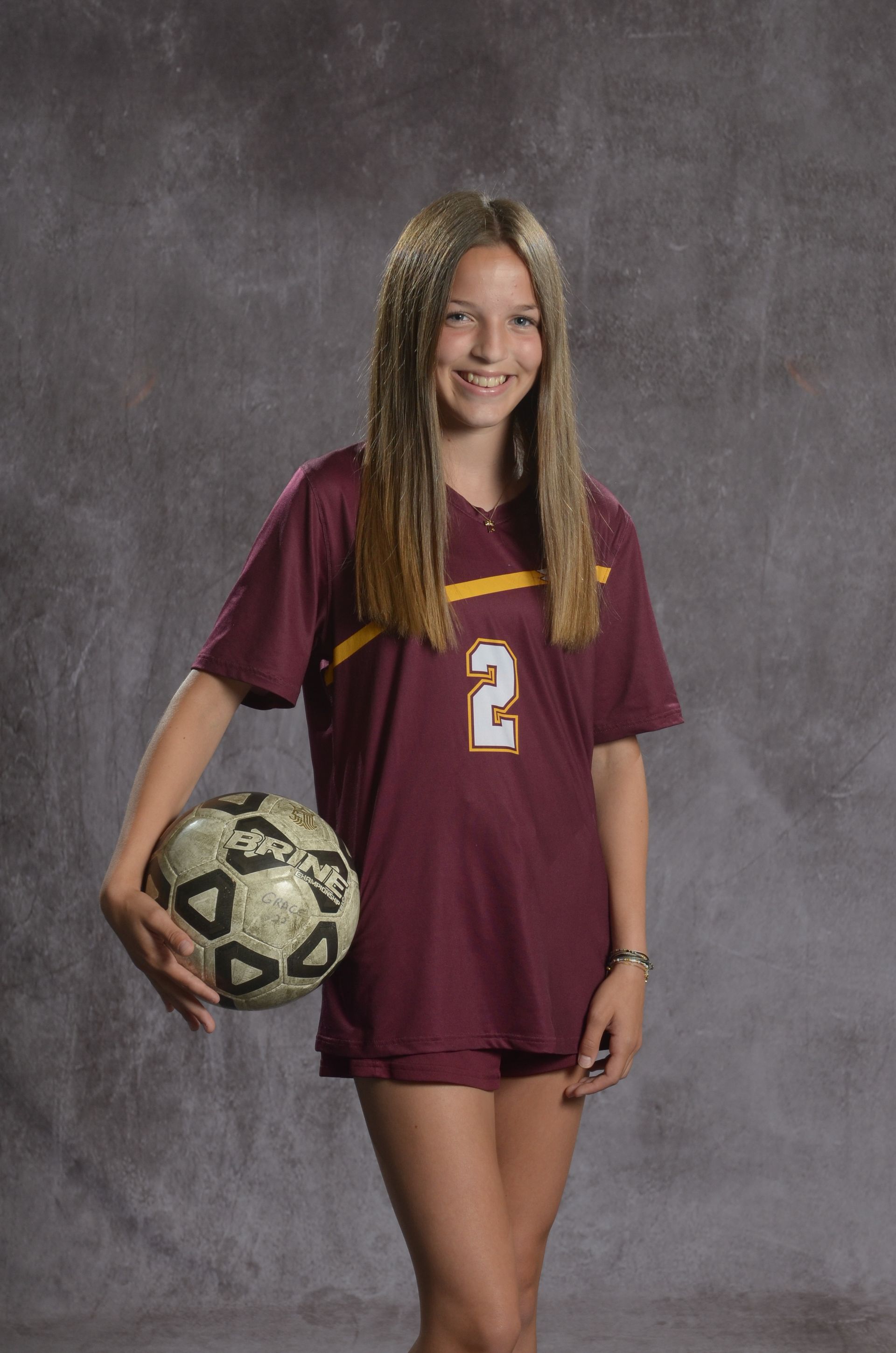 Eagle head logo, maroon feathers and yellow beak, facing right.