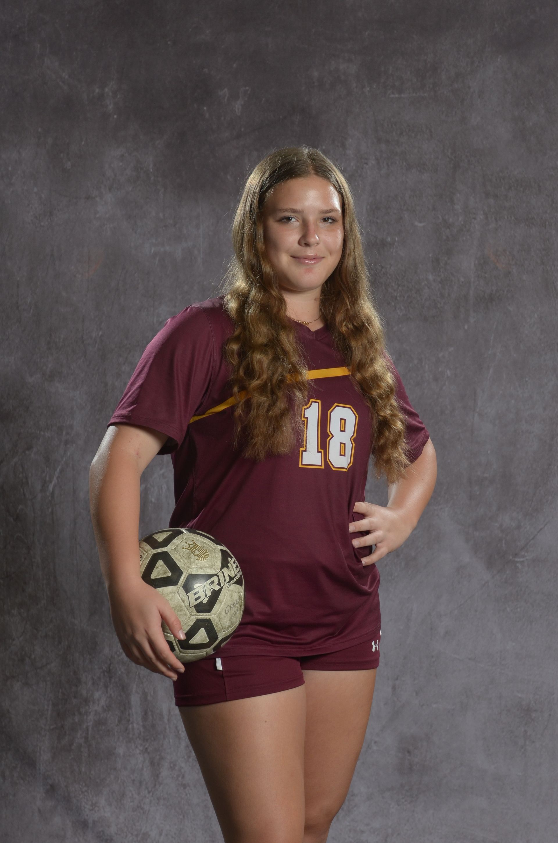 Eagle head logo, maroon feathers and yellow beak, facing right.
