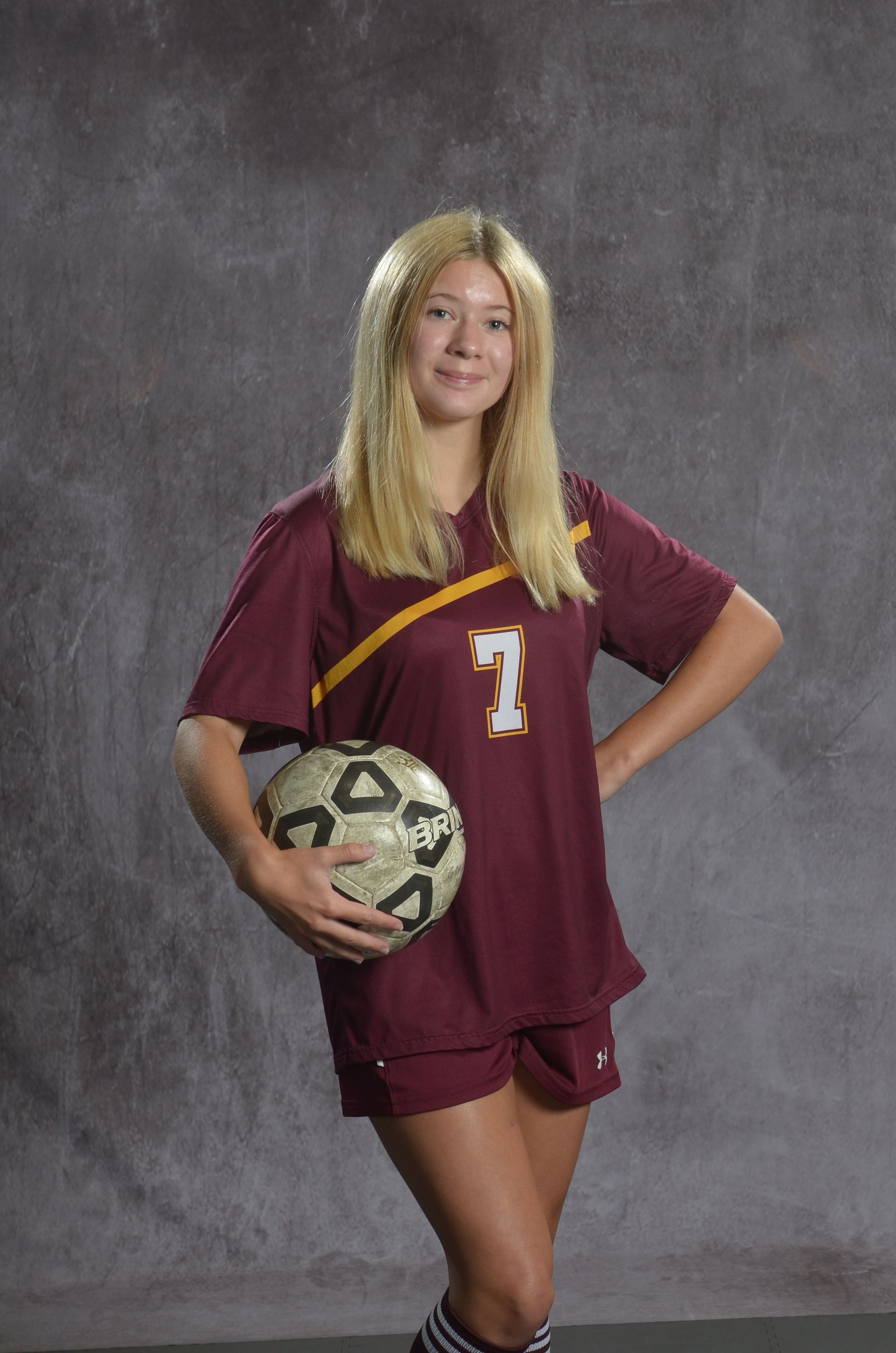 Eagle head logo, maroon feathers and yellow beak, facing right.
