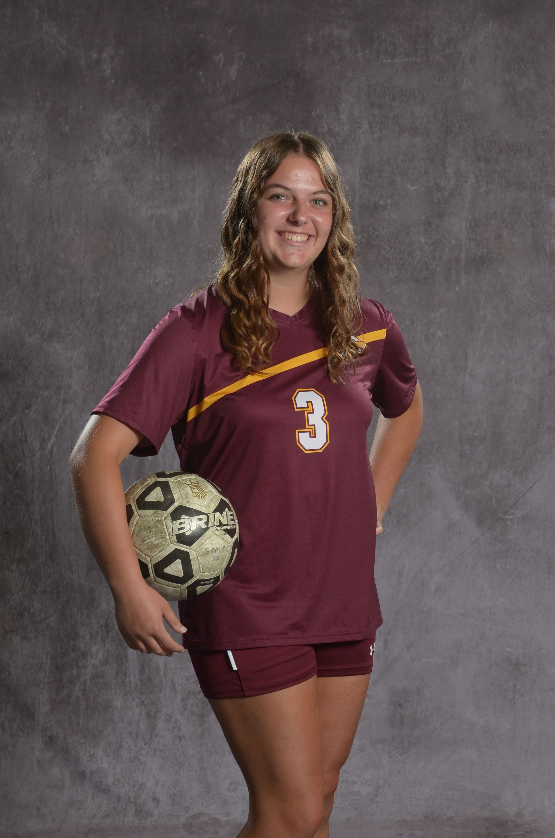 Eagle head logo, maroon feathers and yellow beak, facing right.