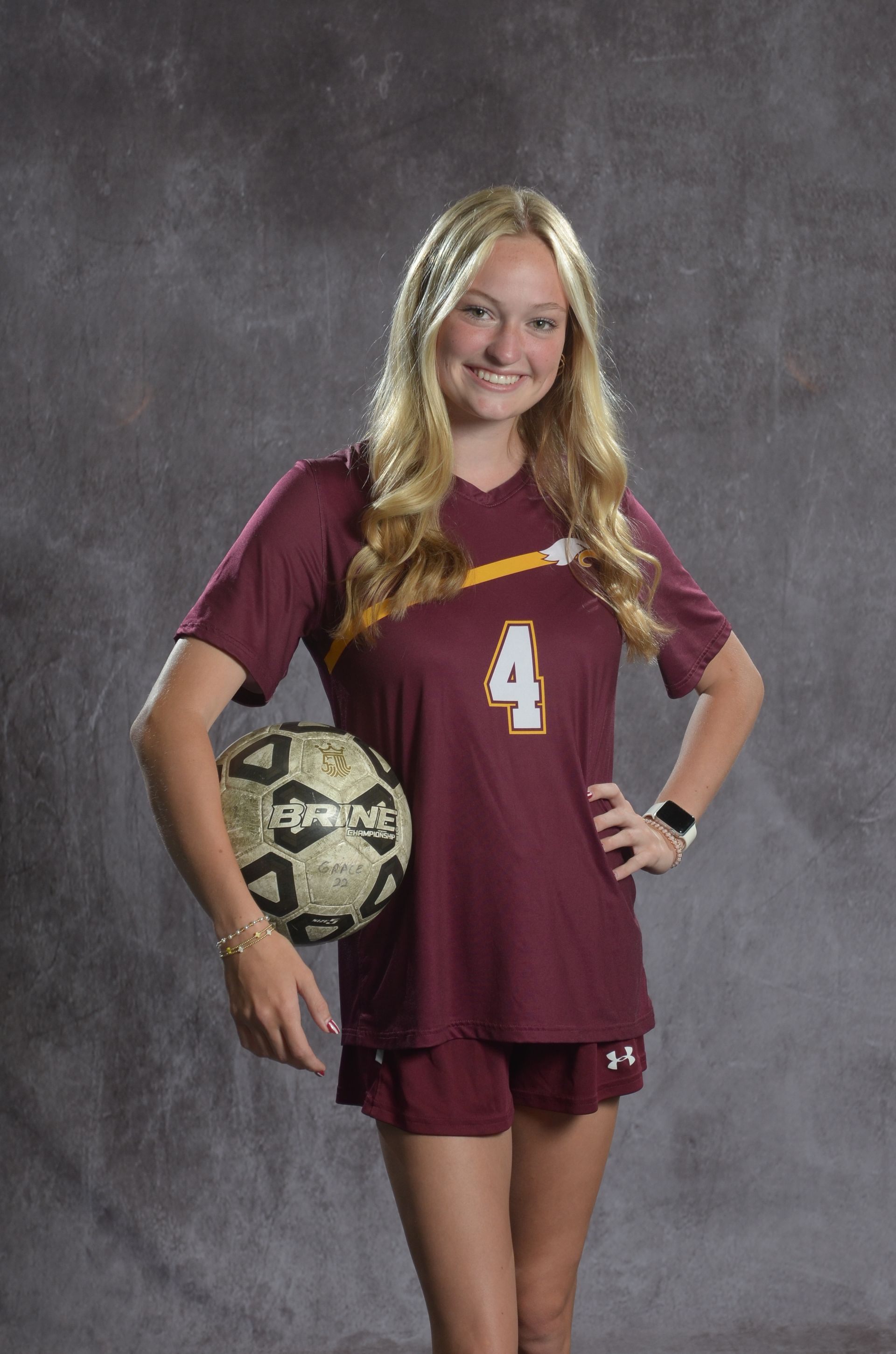 Eagle head logo, maroon feathers and yellow beak, facing right.