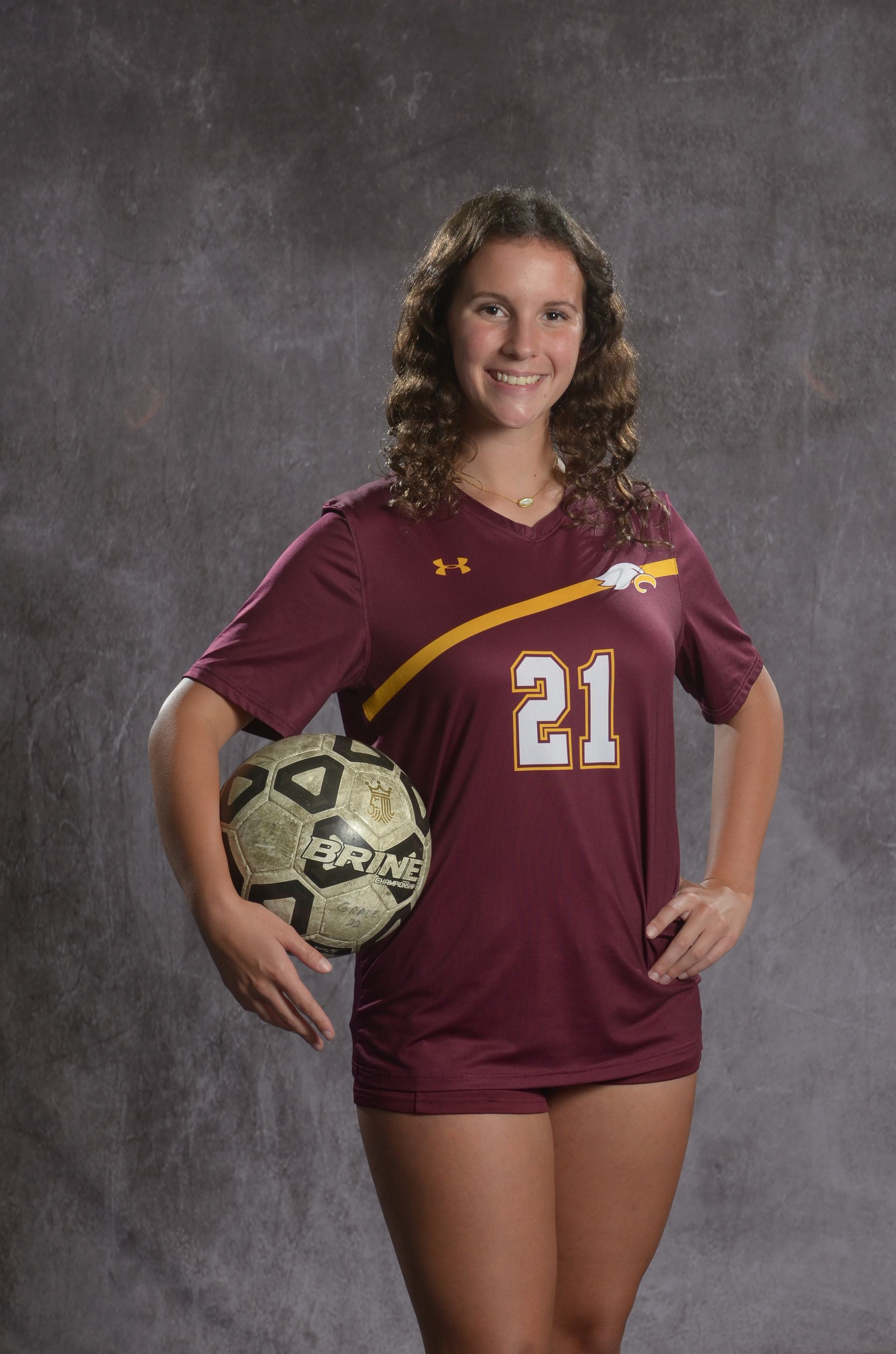 Eagle head logo, maroon feathers and yellow beak, facing right.