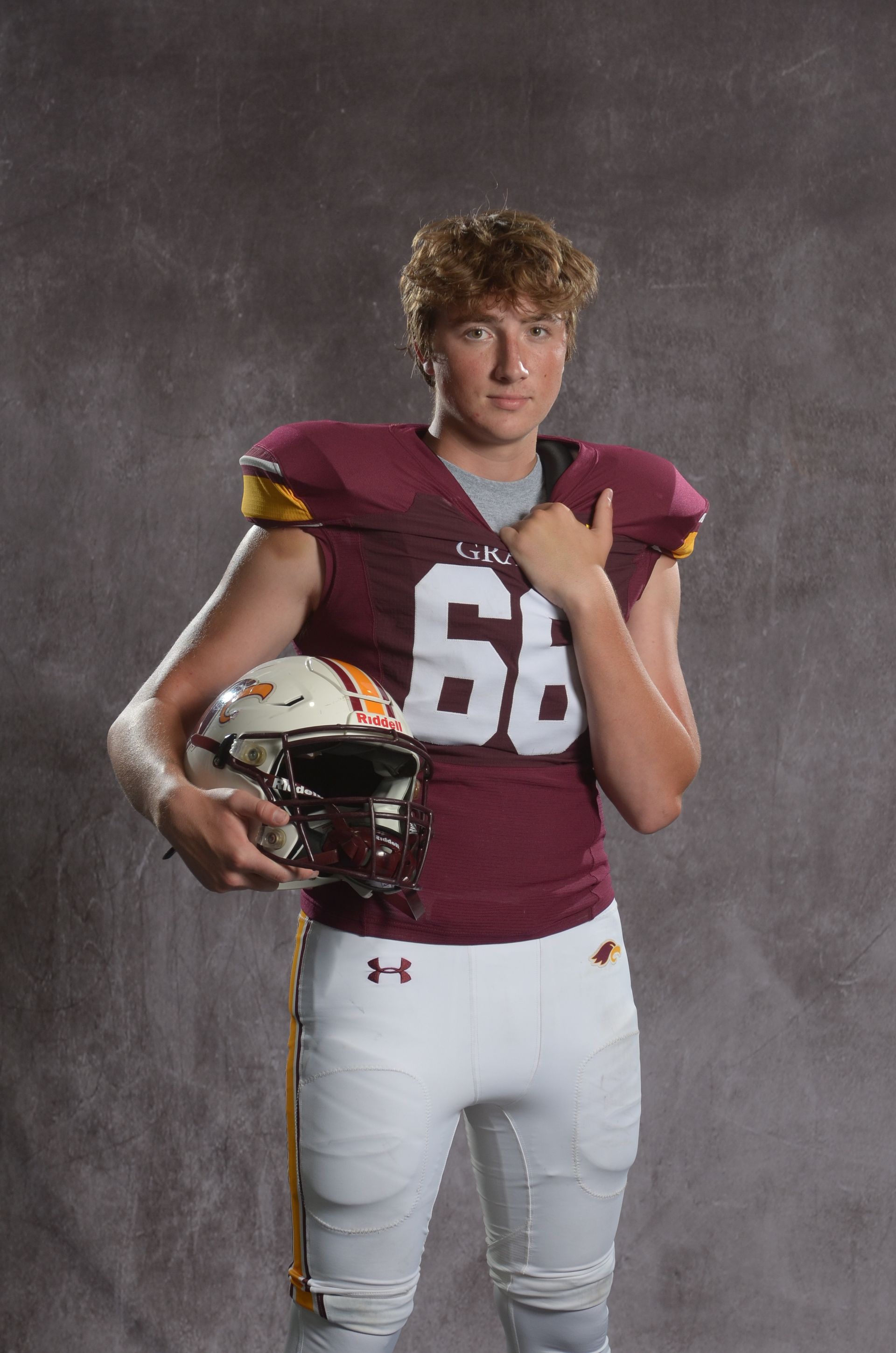 A maroon eagle head logo with a yellow beak on a white background.