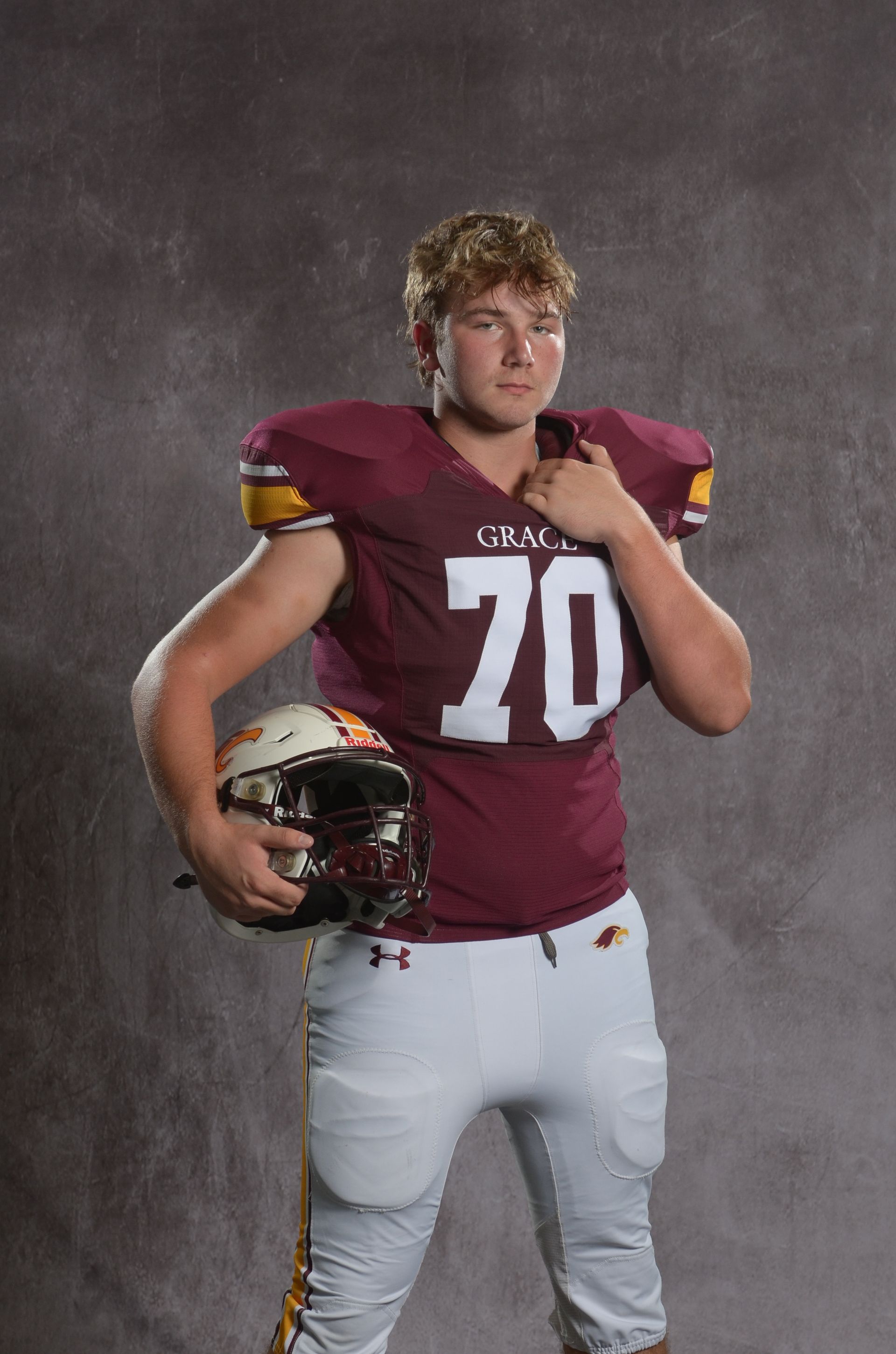A maroon eagle head logo with a yellow beak on a white background.
