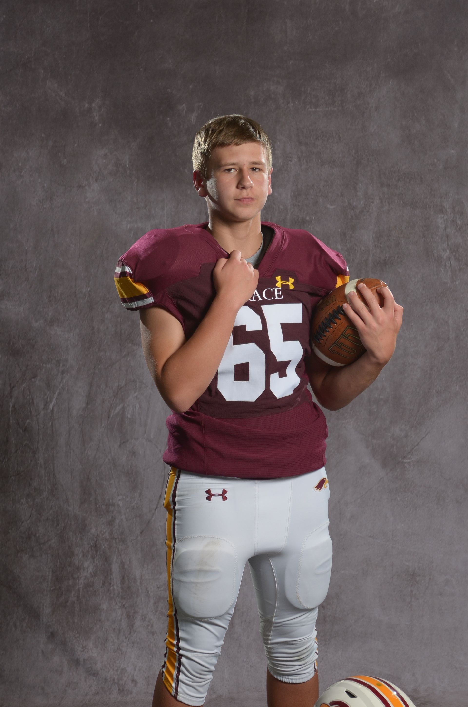 A maroon eagle head logo with a yellow beak on a white background.