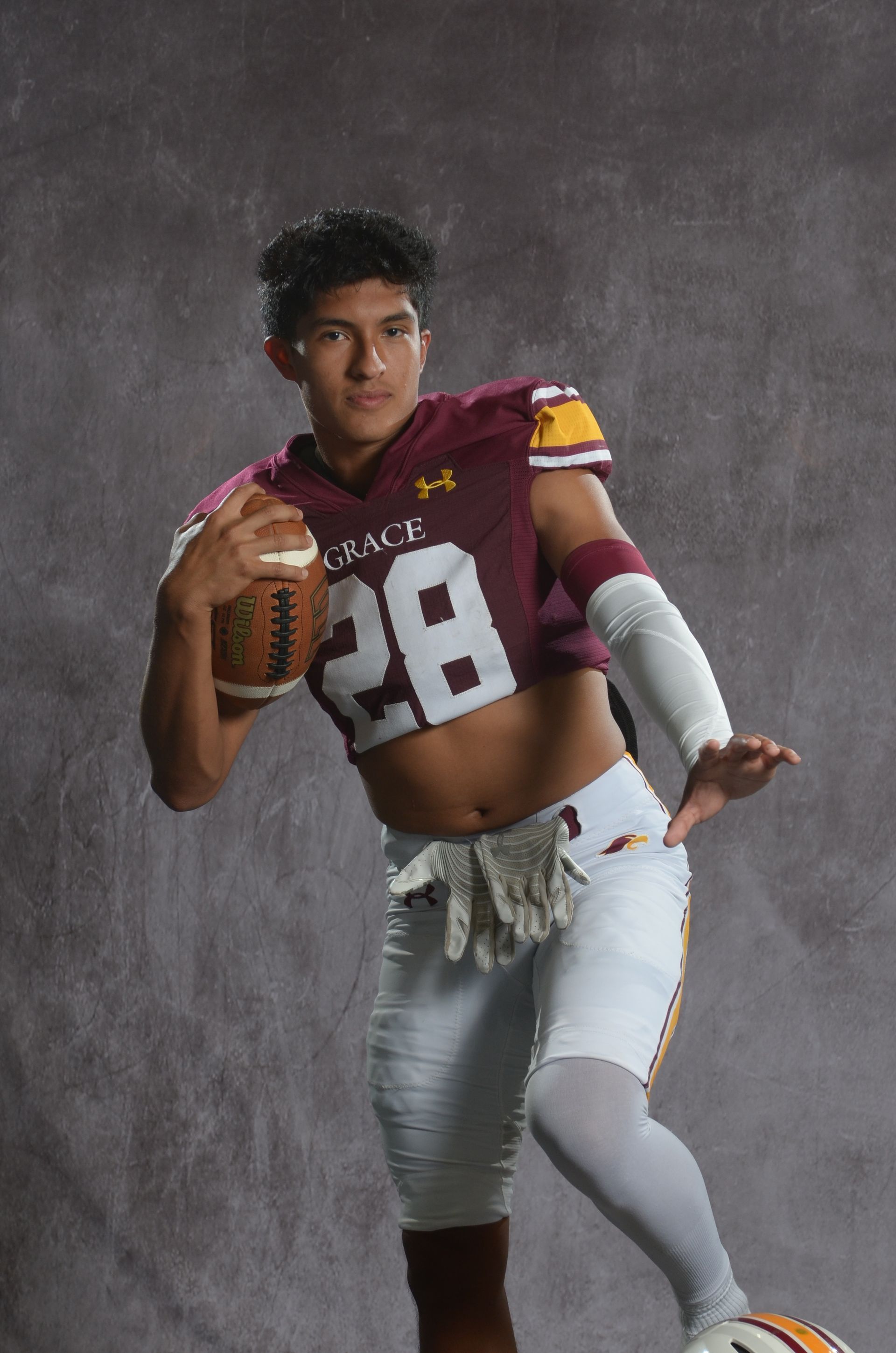 A maroon eagle head logo with a yellow beak on a white background.