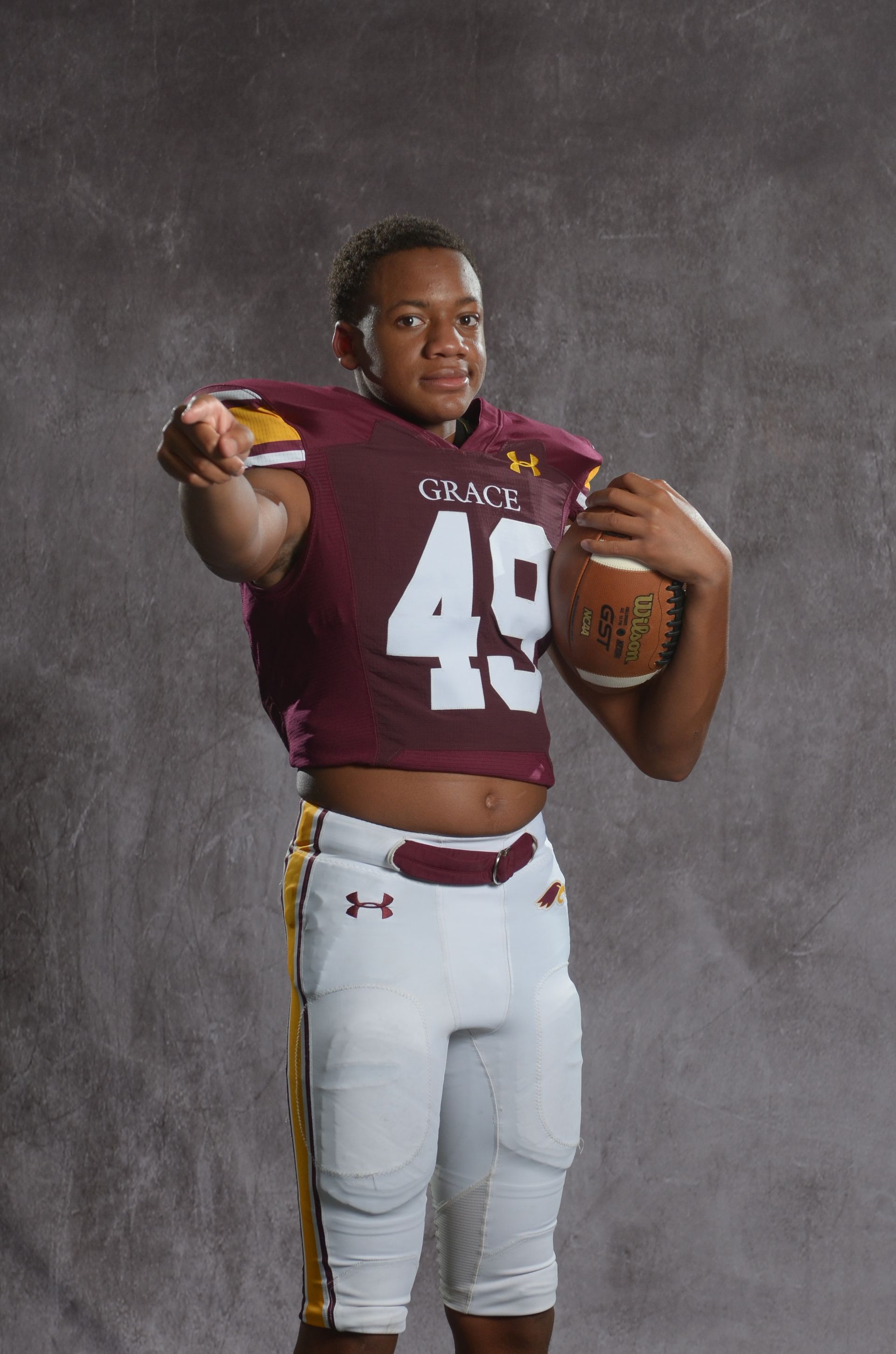 A maroon eagle head logo with a yellow beak on a white background.