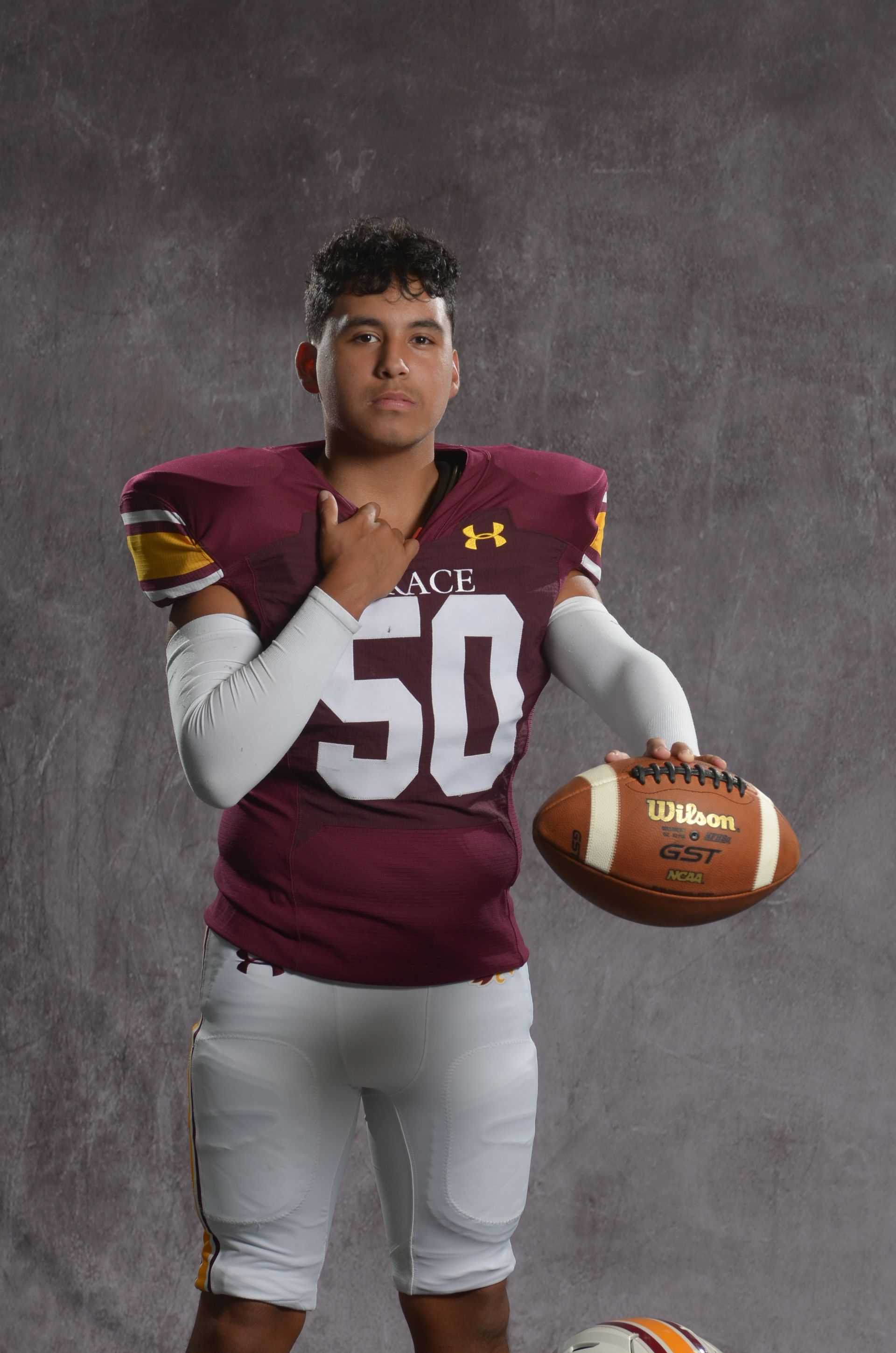 A maroon eagle head logo with a yellow beak on a white background.