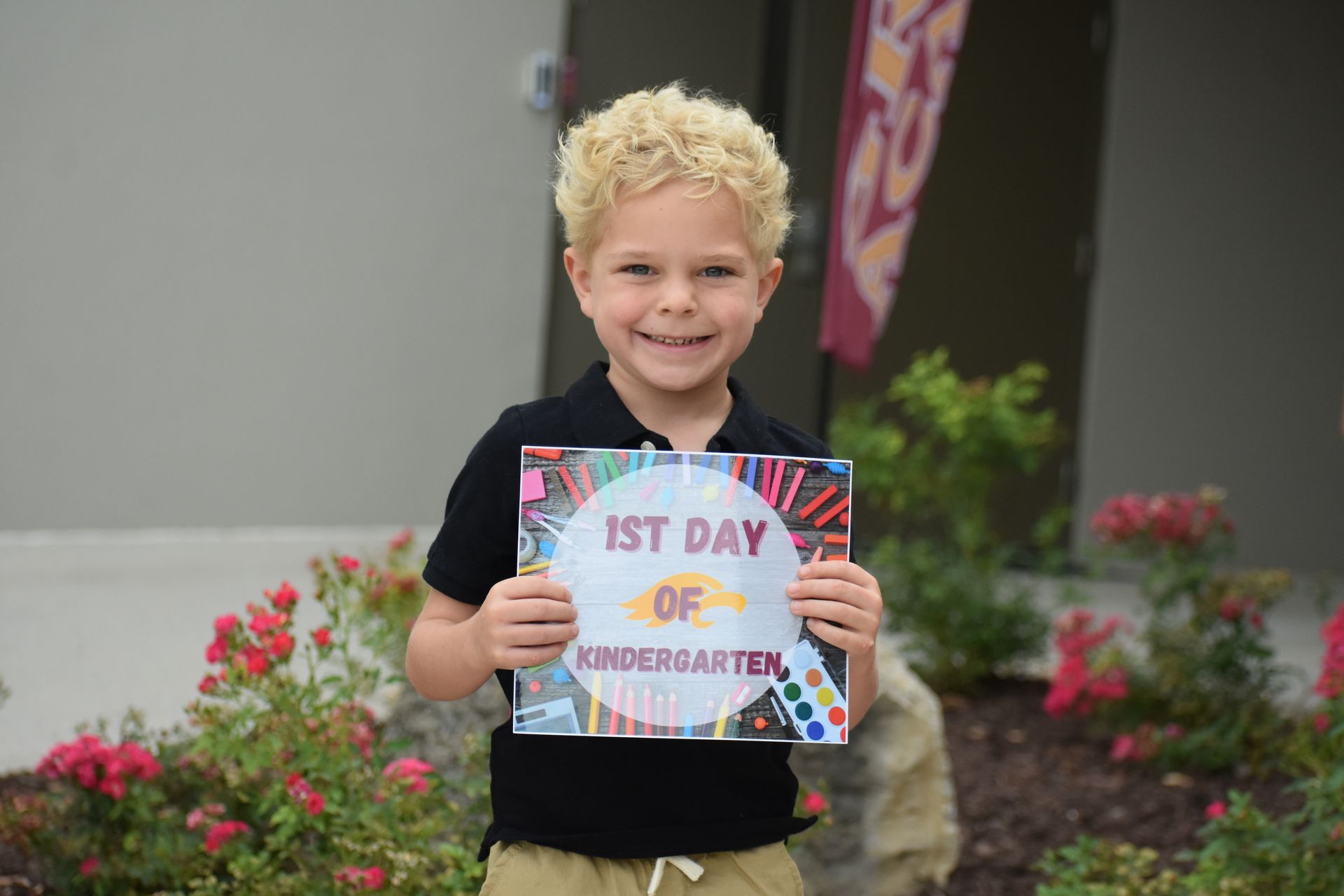 Boy with curly blonde hair holds a 