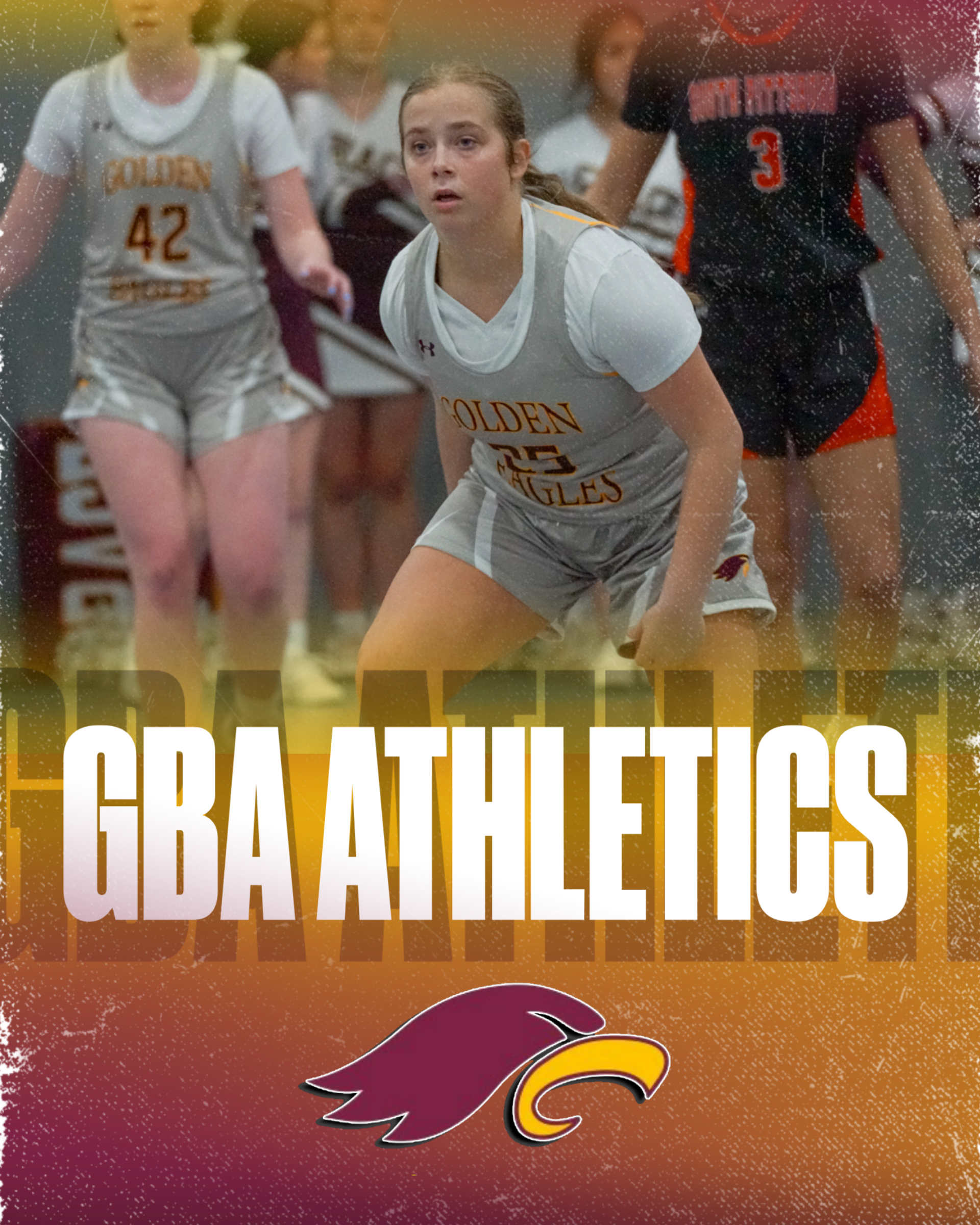 A girls' soccer team in maroon uniforms kneels on a grassy field with their coach.