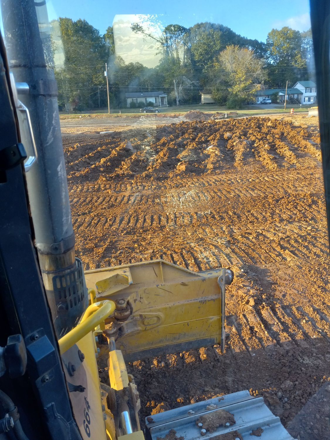 A bulldozer is moving dirt on a construction site.