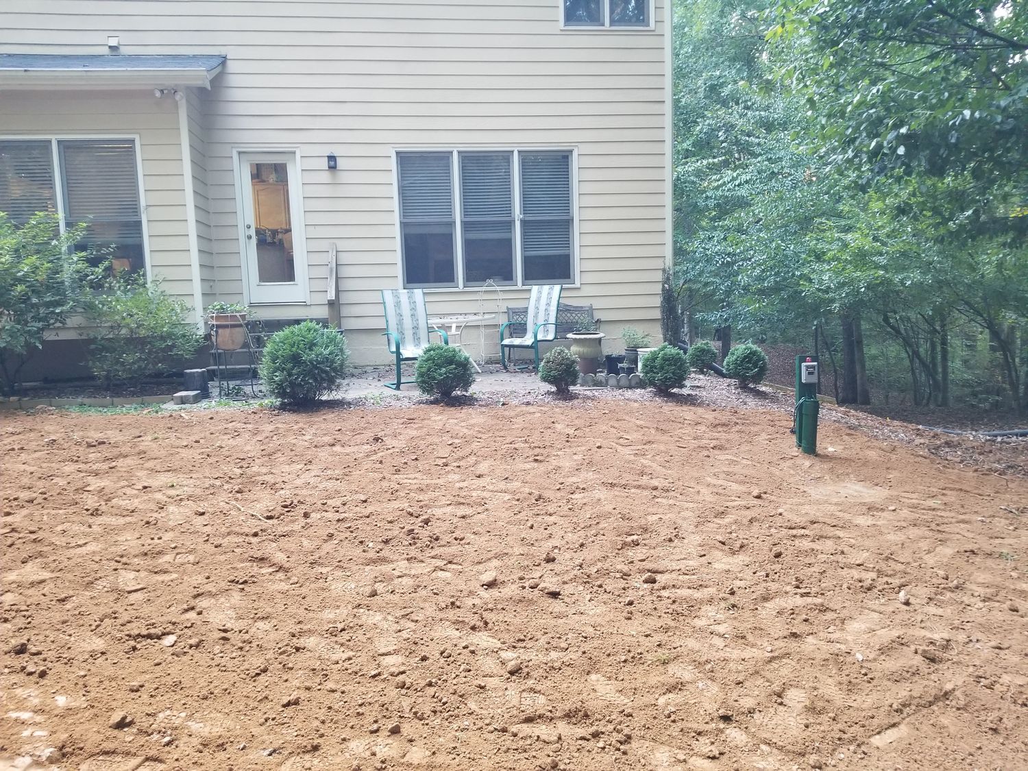 A house with a lot of dirt in front of it.