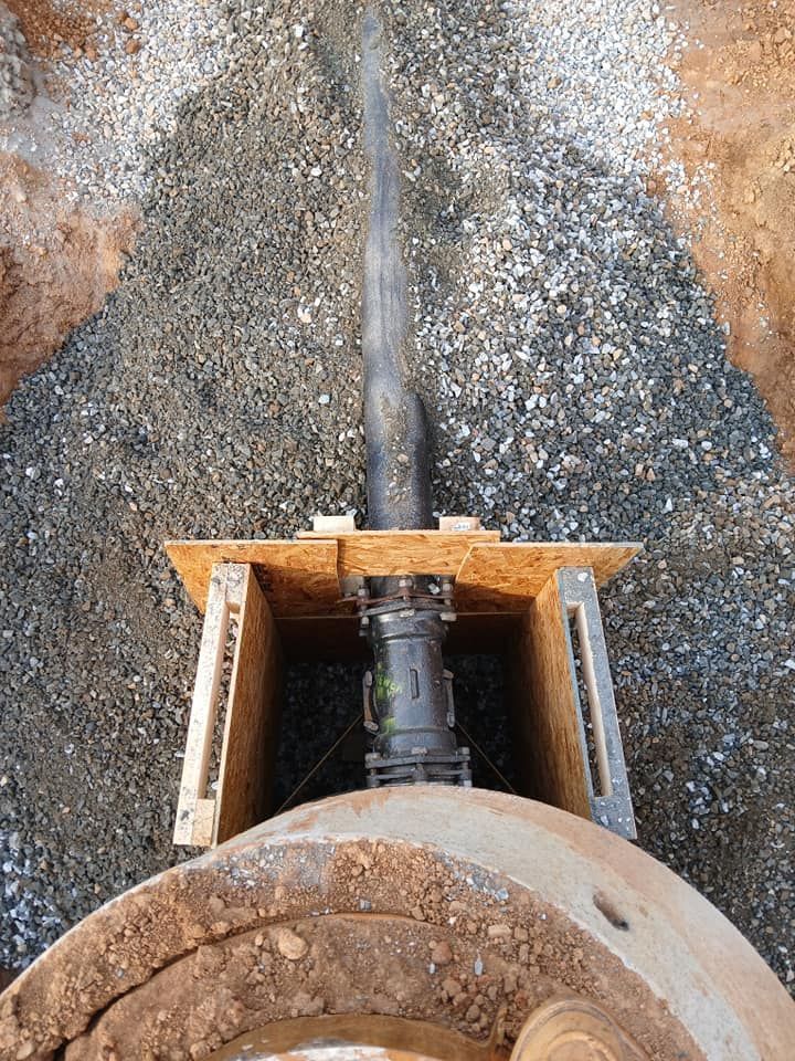 A pipe is coming out of a hole in the ground.