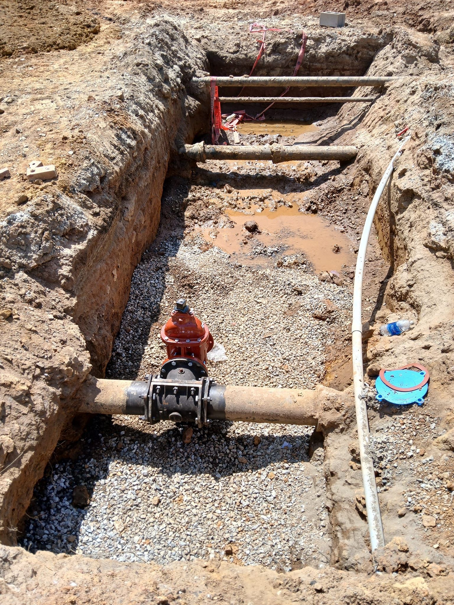 A pipe is being installed in a hole in the ground.