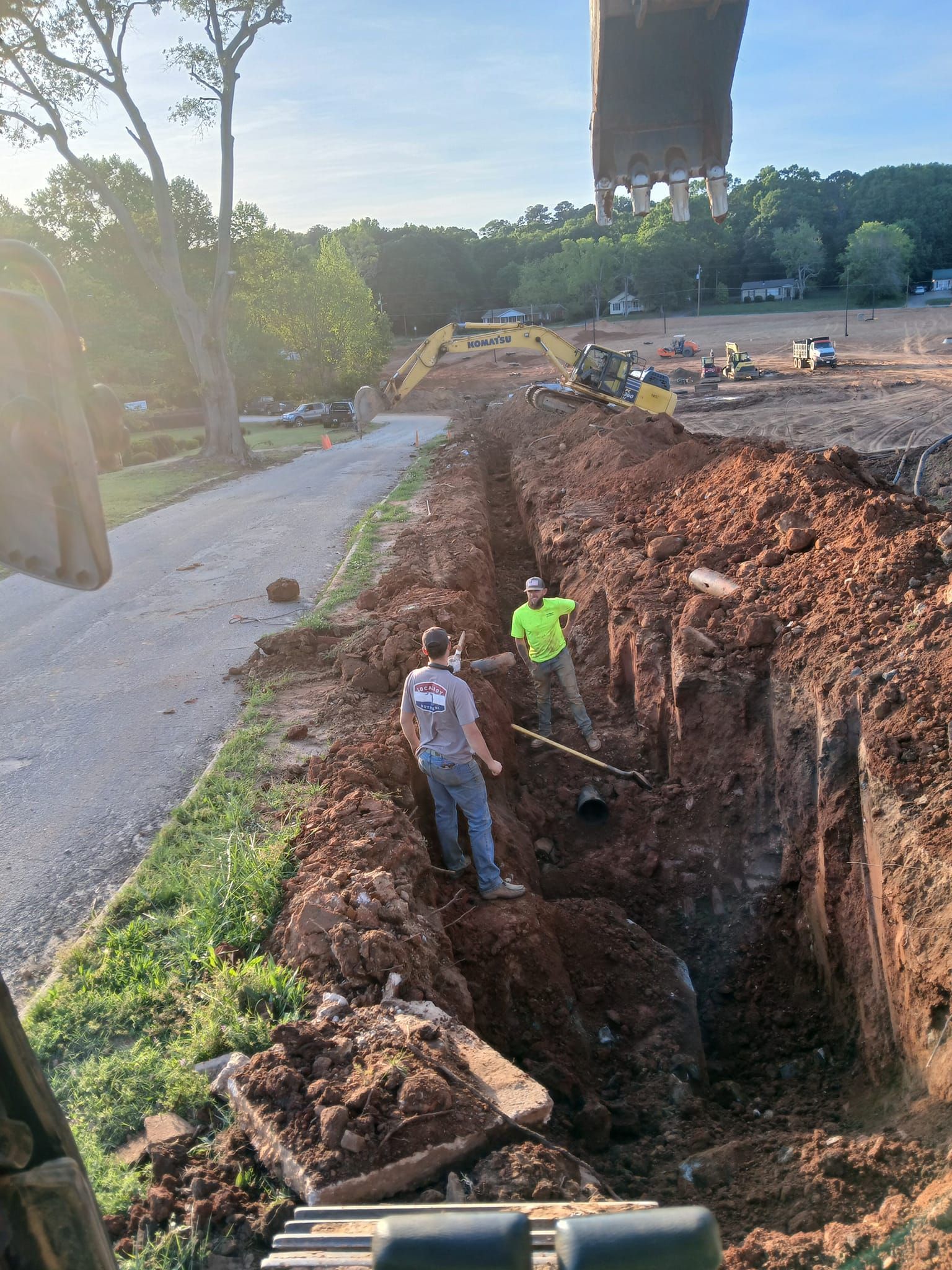 A couple of men are digging a hole in the dirt.